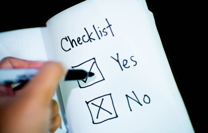 A notebook featuring a checklist with a marked 'Yes' box, captured in a close-up shot.
